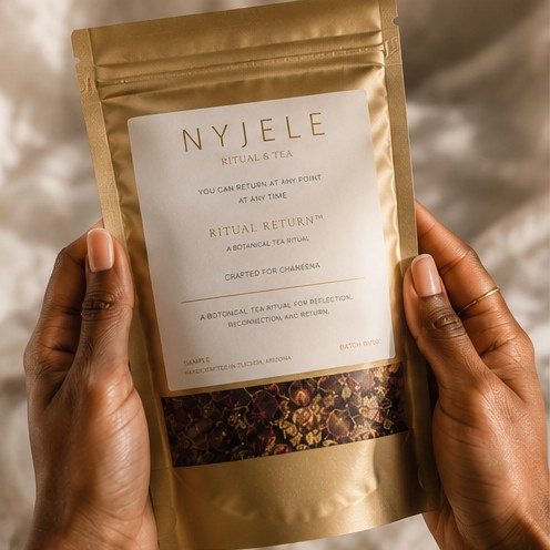 A woman holding a gold Nyjele Ritual & Tea pouch in both hands
